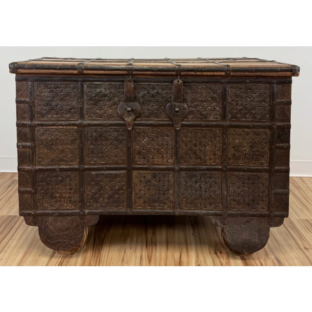 Large antique Indian wedding trunk on wheels. Features strong wood, incredible metal hardware, and fine detail work. This...