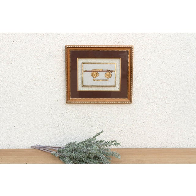 This Indian miniature painting focuses on the defensive and decorative aspects of the Rajput armory. The artwork features...