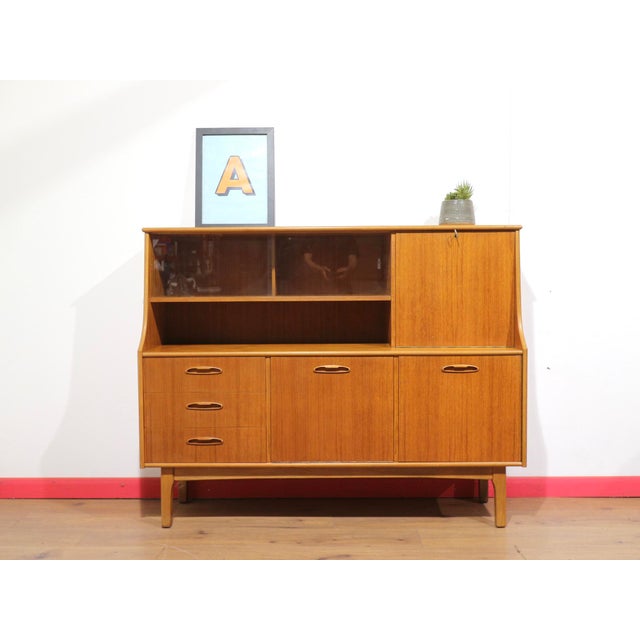 This gorgeous tall credenza in the manor of British furniture maker Jentique offers great storage space while showcasing...