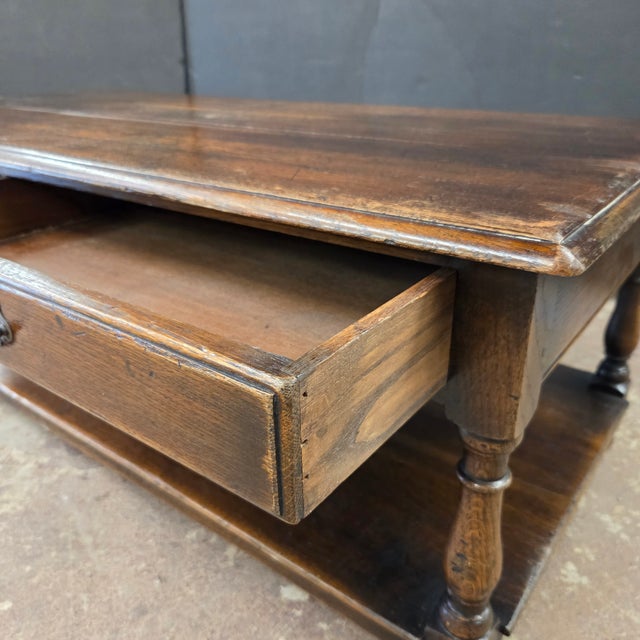 This English Cherry 2 Drawer Turned Leg Potbaord Base Coffee Table has a beautiful patina making it a beautiful accent to...
