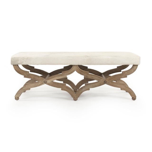 This is a bench featuring a sophisticated design with cowhide upholstery and an oak wood frame. The upholstery showcases a...