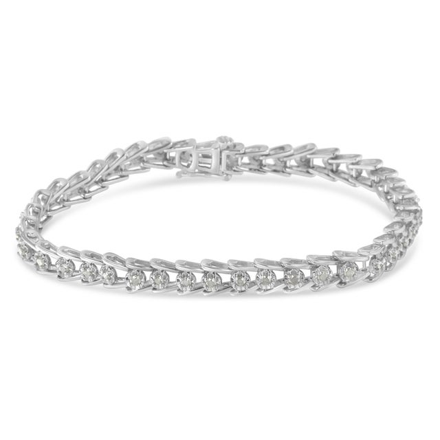 Illuminate her wrist with this alluring sterling silver bracelet, set with a wave-link design. This piece has 40 rose-cut...