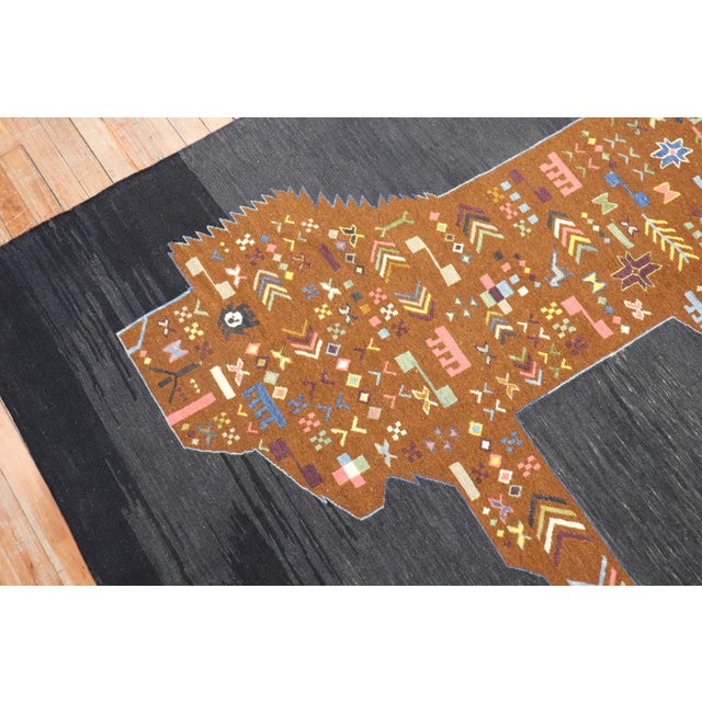 Accent size Persian Kilim from the late 20th century with a lion sitting on a striated black grey field. Measures: 5'1'' x...