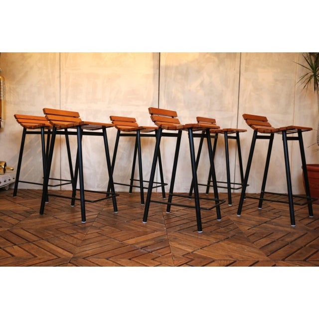 An exceptional set of six mid-century modern bar stools from the 1960s, distinguished by their refined proportions and...