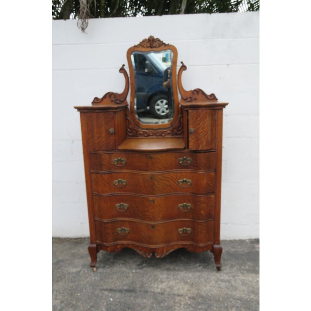 This rare Gentlemen's Chest and Mirror made out of wood, solid wood, solid oak, solid tiger oak, veneer, mirror, and...