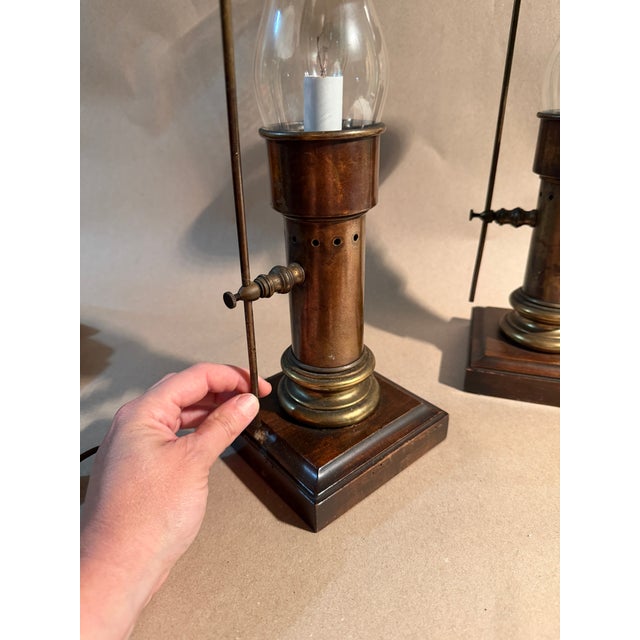 Hobbyist made, antique oil lamps outfitted with electric. Shade hat’s slide up and down the brass pole is adjusted by...