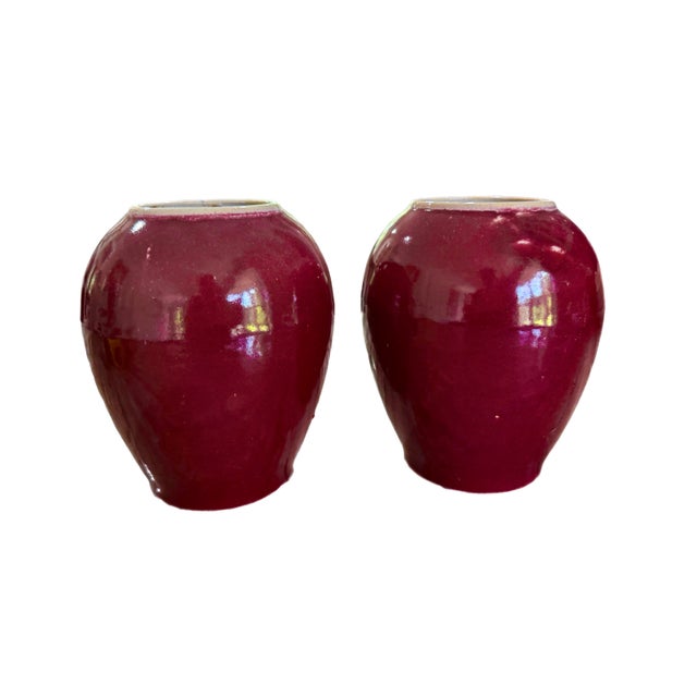 A matched pair of sang de boeuf or oxblood vases. Unsigned. Circa mid 20th century.