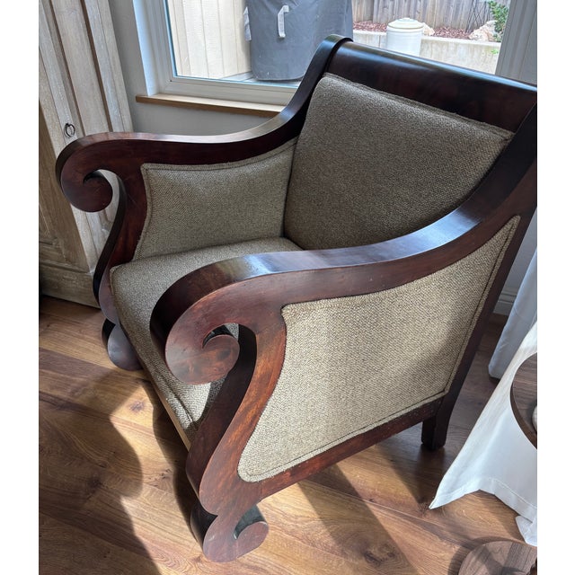 This is an early 19th century Empire Revival lounge armchair featuring heavy, architectural "S" scroll arms and matching...