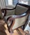This is an early 19th century Empire Revival lounge armchair featuring heavy, architectural "S" scroll arms and matching...
