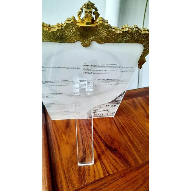 This frame is made from a vintage evening handbag, as you can see at the top,where the closure clasp is.