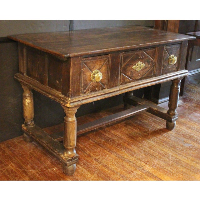 17th century English oak server. Blackened with the patination of centuries. Three drawers, the central with diamond...