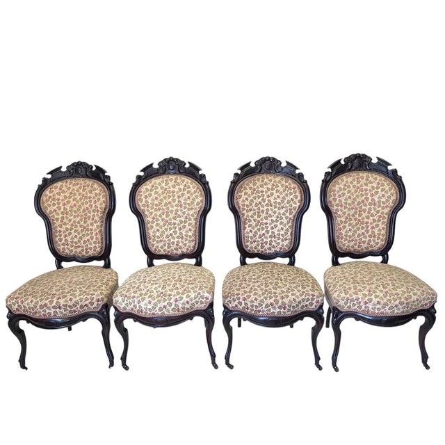 Add some opulence to any room with this splendid set of 4 beautifully carved antique American ballon-back rosewood chairs....
