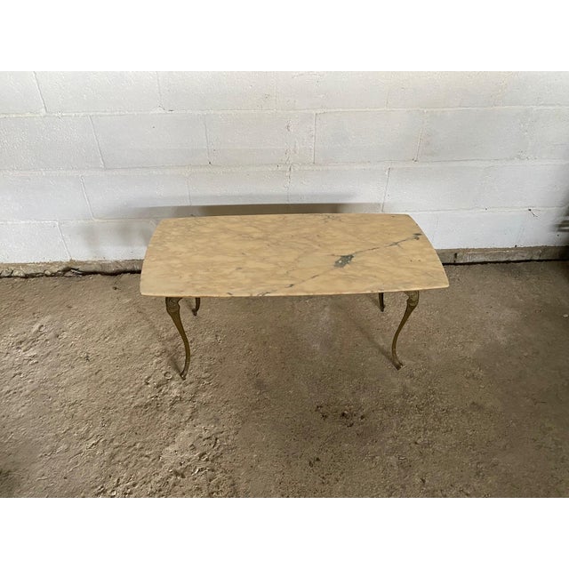 Beautiful coffee table with marble top Brass base Various signs of use, good condition, no cracks or breakages A few tiny...