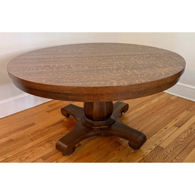 Antique Arts & Crafts round pedestal tiger oak dining table. Built from a premium grade of white oak with bold quartersawn...