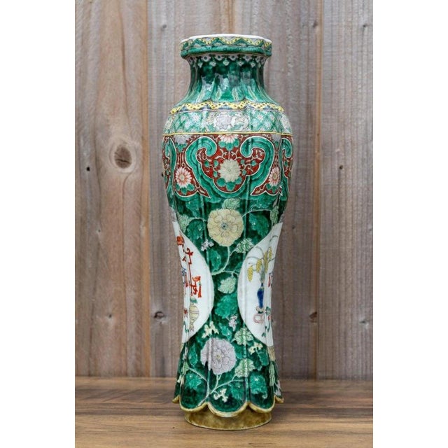 A striking antique Chinese porcelain vase dating to the early 19th century, during the Qing dynasty, and decorated in the...