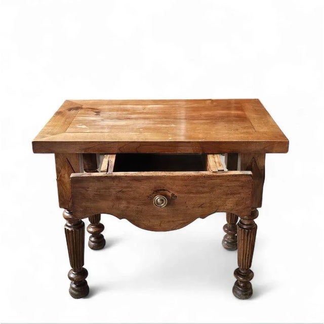 This charming early 20th-century French Provincial side table brings timeless elegance and functionality to any space....