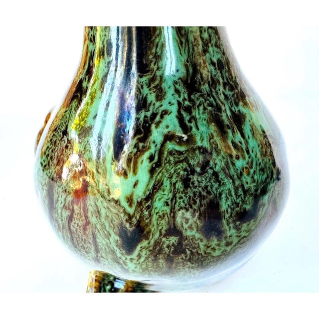 A well-executed vintage ceramic duck figurine finished in a richly variegated drip glaze of emerald green, olive, and deep...