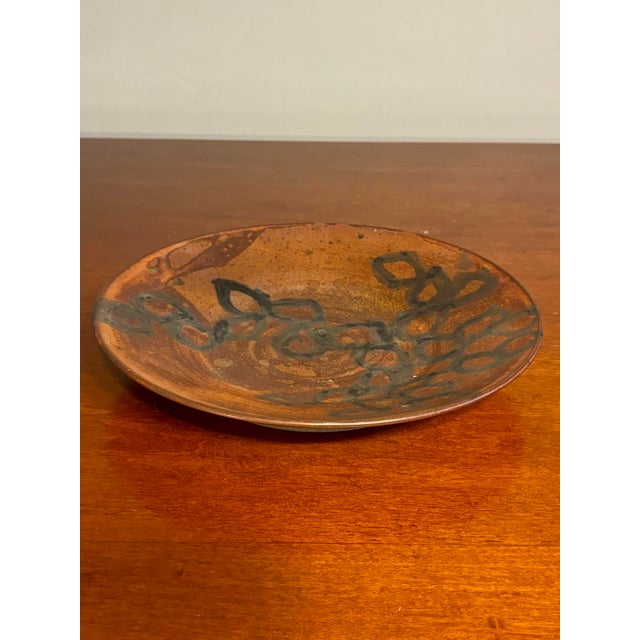 This mid-century modern studio ceramic plate dates to the 1960s and showcases the expressive, tactile qualities...