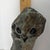 The object is a hand-carved stone owl sculpture created in the distinct tradition of Zimbabwean Shona art. It is crafted...