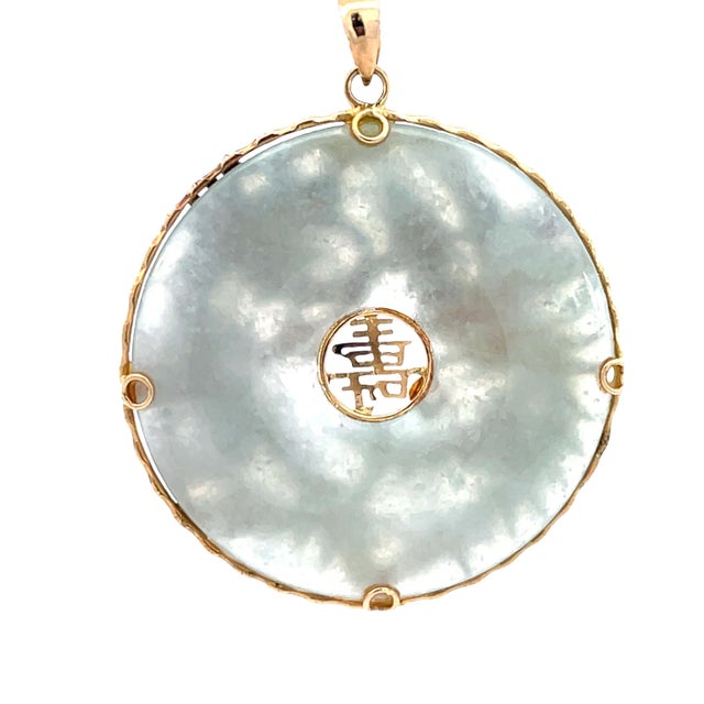 Striking vintage 14K yellow gold Chinese pendant featuring a detailed dragon and phoenix design, symbolizing harmony and...