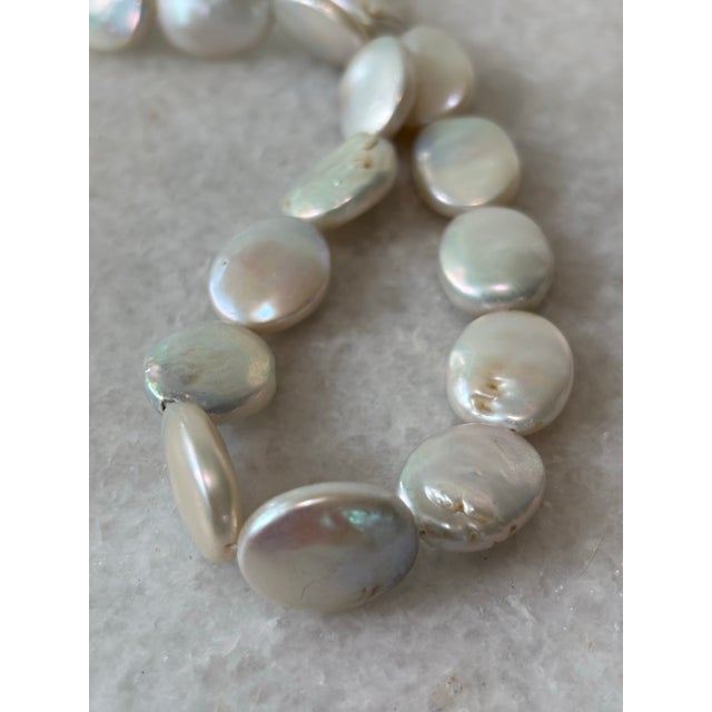 Absolutely stunning vintage pearl necklace with disc shape pearls, and sterling silver clasp.