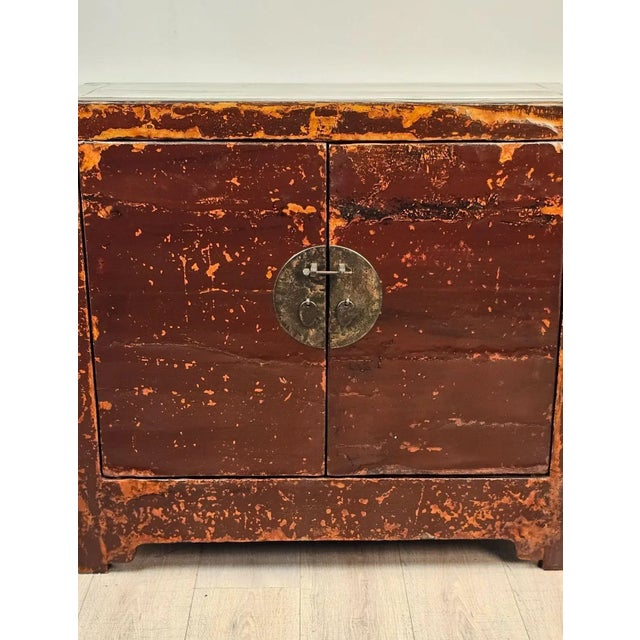 A cinnabar painted Chinese cabinet, late 19th century. Lacquer worn.