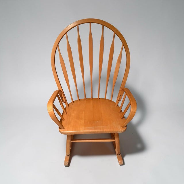 A wonderful large and comfortable rocking chair. Bowed back and arms with tapered spindles. Handmade of solid oak.