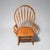 A wonderful large and comfortable rocking chair. Bowed back and arms with tapered spindles. Handmade of solid oak.