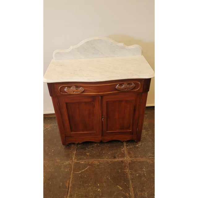 A nice cabinet solid cherry wood with a white marble top. A Washstand Commode stand that now can be used for many...
