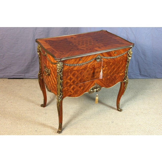 A combination commode forming a dressing table and writing desk in marquetry wood, after a design by Jean-François Leleu...