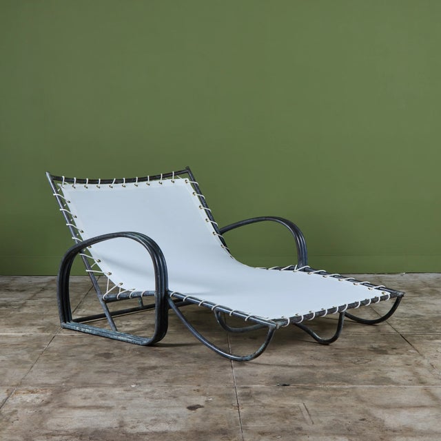 Late 1940s or early 1950s double width patio lounge chair by Walter Lamb predating his partnership with Brown Jordan. The...