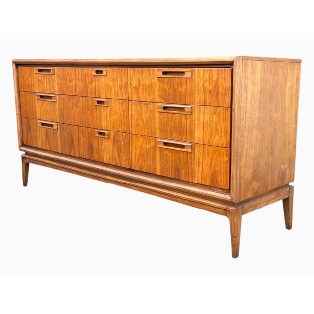 A beautifully restored Mid-Century Modern dresser showcasing the timeless appeal of Danish Modern design. Crafted in...