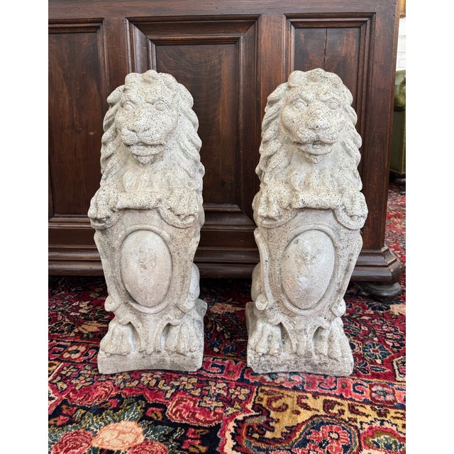 Classic and substantial, this pair of American-made cast concrete lion statues dates to the 1940s and embodies the...