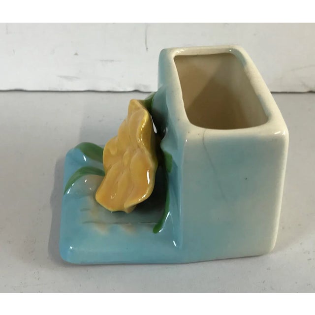 Cute little box like planter with a flower on front. Signed Zanesville USA on bottom. Great for a small succulent or herb!