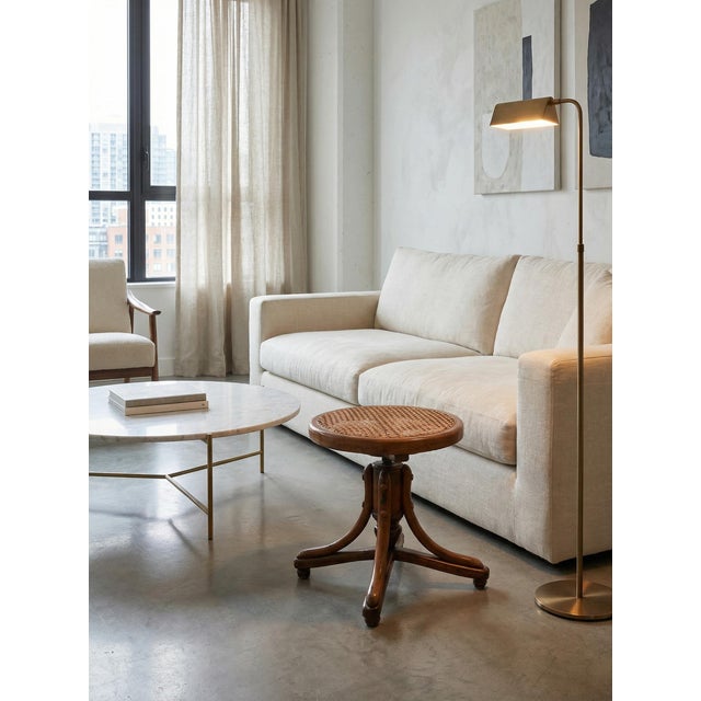 An elegant vintage stool in Central European style, crafted from solid steam-bent beech. This piece combines the...