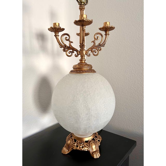 1960s Hollywood Regency candelabra table lamp featuring a striking blend of neoclassical elegance and dramatic mid-century...