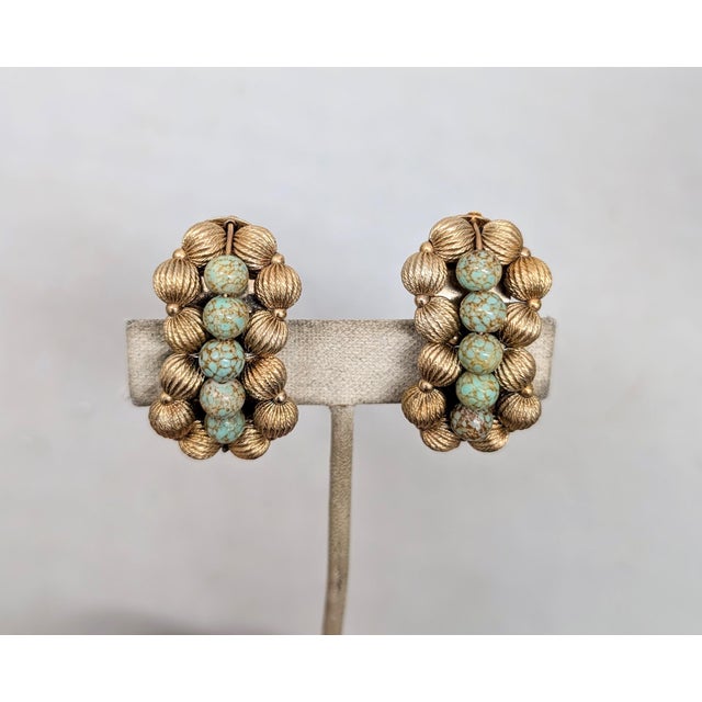 1950s goldtone ribbed beads with a line of speckled faux-topaz beads down the center clip earrings. Marked "NAPIER PAT....