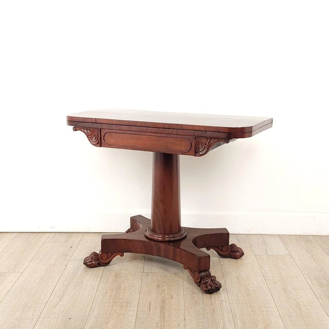 A very good William IV English mahogany pedestal table, circa 1830, with lion's paw feet and anthemion scrolls supporting...