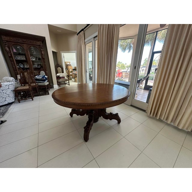 A documented French carved oak extension dining table in the Louis XIII hunting style, circa 1860, accompanied by the...