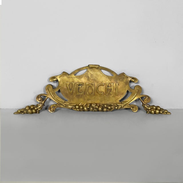 Italian Art Deco Venchi brass sign, 1940s Brass sign with the Venchi logo and swirl and fruit decorations. Art Deco style....