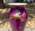 Beautiful hand blown glass vase with 22 kt gold accents. Various shades of purple with clear foot and opaline color...