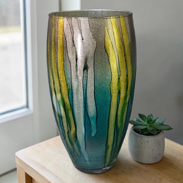 This modern large 14'' Italian art glass vase exudes a unique and artistic flair, featuring a stunning teal, gold, and...