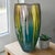 This modern large 14'' Italian art glass vase exudes a unique and artistic flair, featuring a stunning teal, gold, and...