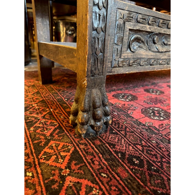A richly carved antique bench with remarkable presence and sculptural detail. This substantial wood bench features a...