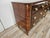 An elegant Italian chest of drawers dating back to the 1950s, characterized by a strong decorative presence and a refined...