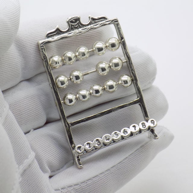 A nostalgic vintage miniature abacus, expertly handmade in Italy during the 1980s–1990s in genuine silver (800/000). This...
