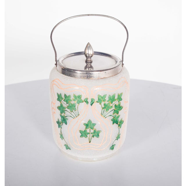 This antique glass cake stand is a charming and functional piece, showcasing elegant craftsmanship. The stand features a...