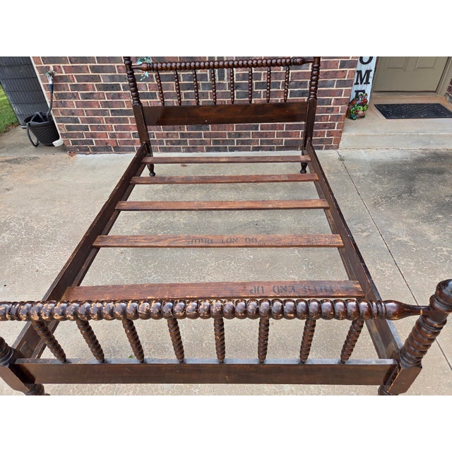 1920s period dark walnut Jenny Lind style full size spindle-type bed frame. Includes the original wooden bed rails and 5...