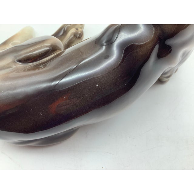 One tiny chip in the glaze on the back of the dog figurine, and one on the black of the head that leads into the neck...