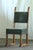 A rare set of four heavy, solid oak chairs made in Denmark in the 1950s. Handwritten in pencil beneath two of the chairs...
